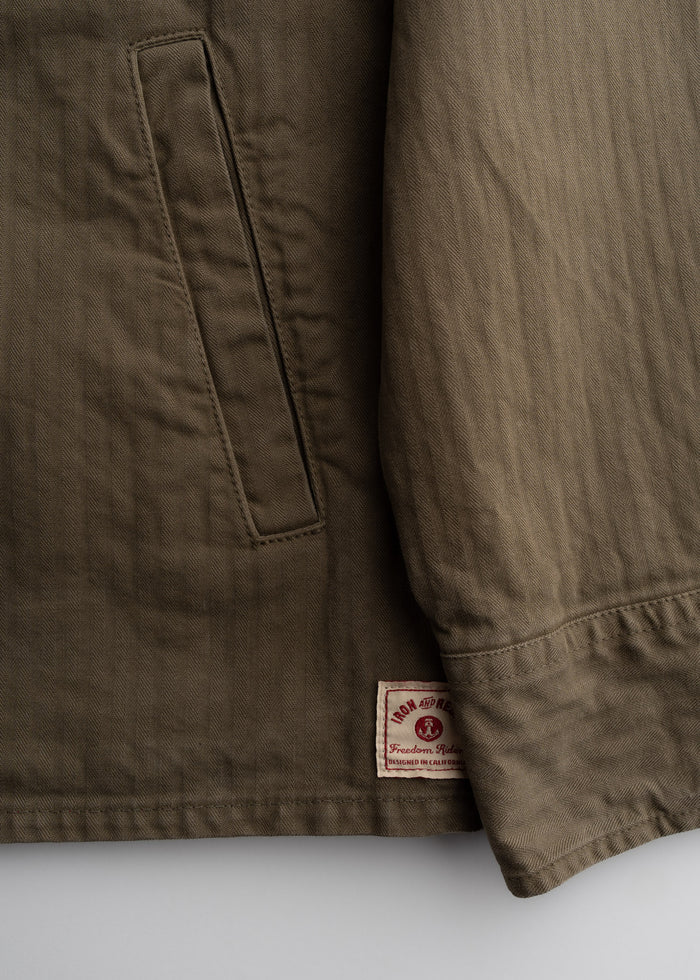 Close up of front pocket, and 9.5 oz cotton herringbone fabric showing textured weave and durable construction
