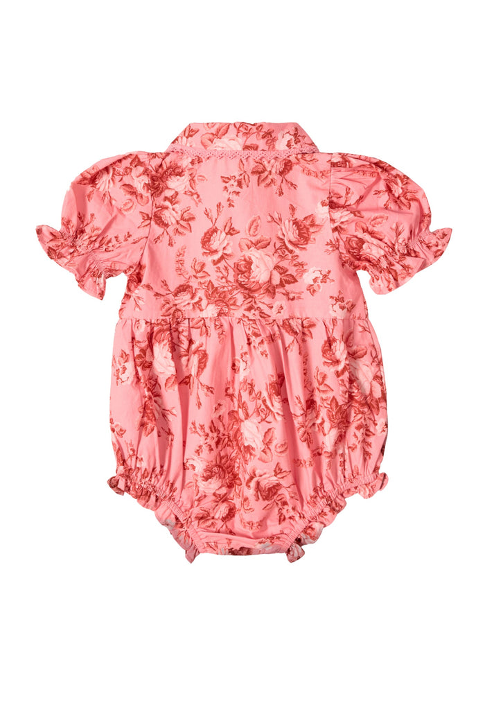 The Baby Sophia Romper in Desert Heritage Rose by Ivy City Co is a pink floral cotton romper for baby girls, featuring short puff sleeves, a collar, and ruffled leg openings, shown from the back on a white background—an ideal Easter outfit.