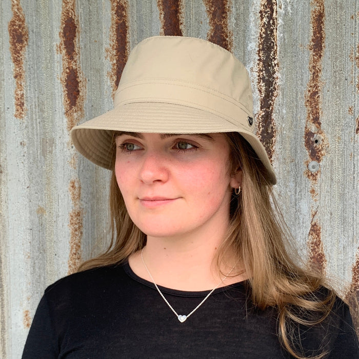 Woman wearing light sand coloured Hydroex rain hat.