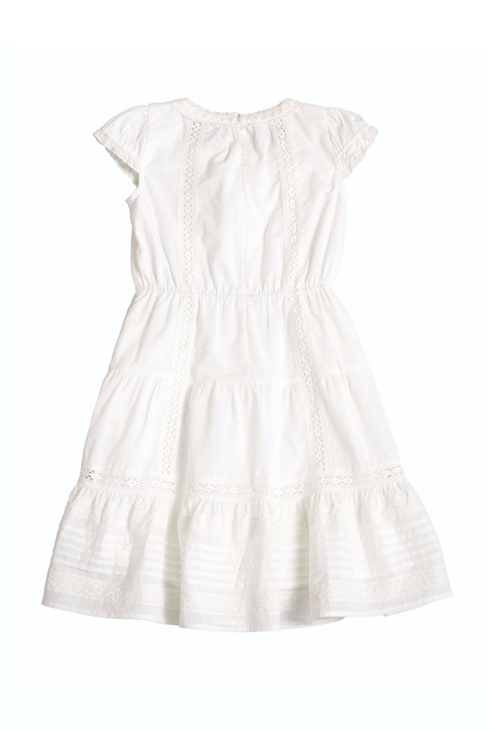 The Ivy City Co Mini Palermo Dress in White, featuring puff sleeves, lace trim, a gathered waist, and a tiered skirt, is displayed flat against a plain white background.
