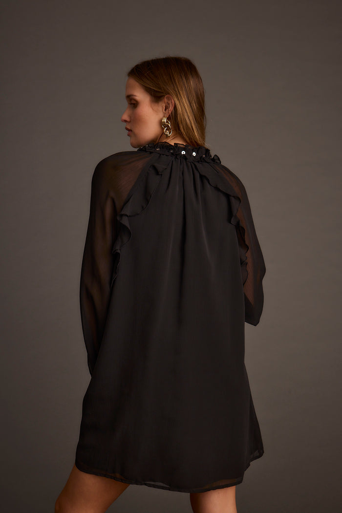 Back view of the black chiffon mini dress showing the silhouette and fit.