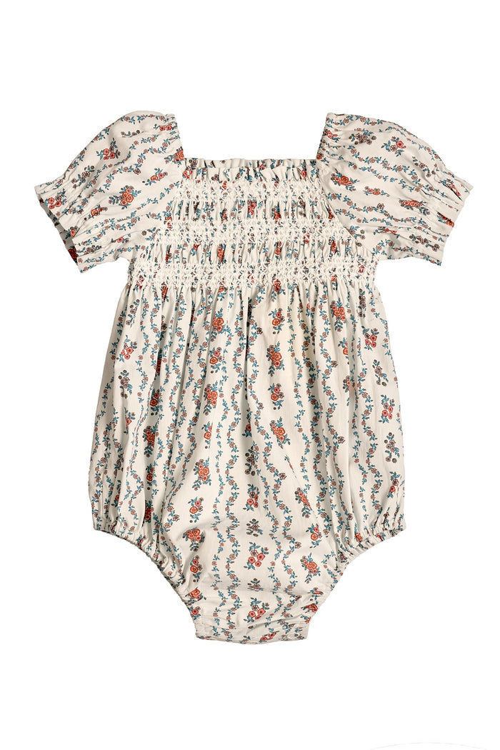 The Ivy City Co Baby Sunday Best Romper in Linear Poppy Woodblock features a cream base, short puffed sleeves, square neckline, elastic-smocked chest, and a red, blue, and green poppy print—ideal for Mom and Me matching.