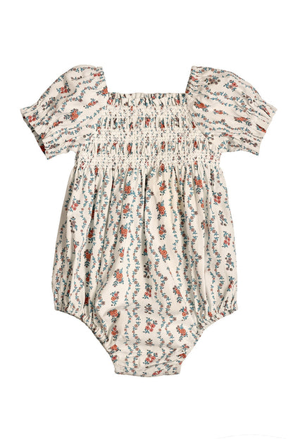 The Ivy City Co Baby Sunday Best Romper in Linear Poppy Woodblock features a cream base, short puffed sleeves, square neckline, elastic-smocked chest, and a red, blue, and green poppy print—ideal for Mom and Me matching.