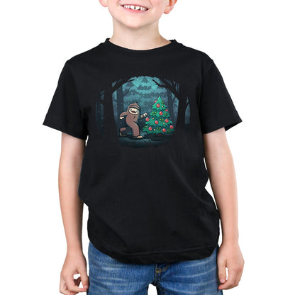 Premium Cotton T-shirt_TeeTurtle black Bigfoot Christmas apparel featuring a sasquatch caught putting holiday decor on a tree in the middle of a snowy forest.