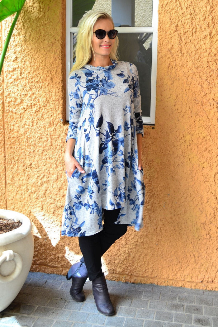 Blue autumn leaf fleece tunic dress by Hourglass, showing a cozy, long-sleeve tunic with a leaf pattern and relaxed fit.