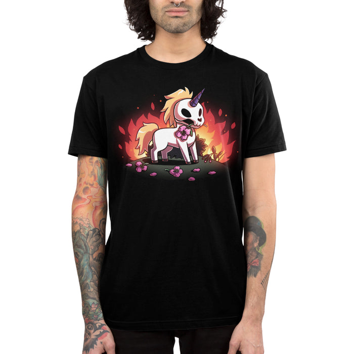 Premium Cotton T-shirt_TeeTurtle black Chaotic Good apparel featuring a skull unicorn holding a pink flower in its mouth with dead flowers at its feet and fire in the background.