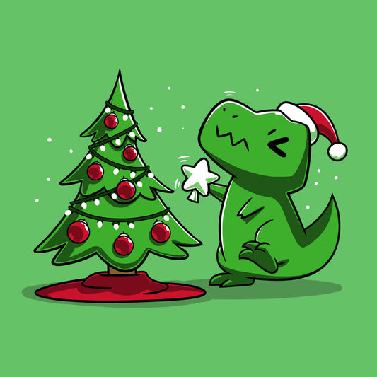 Premium Cotton T-shirt_TeeTurtle Christmas T-Rex apple t-shirt featuring a cartoon dinosaur wearing a Santa hat placing a star atop a Christmas tree adorned with red baubles and lights.