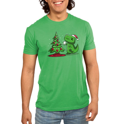 Premium Cotton T-shirt_TeeTurtle Christmas T-Rex apple t-shirt featuring a cartoon dinosaur wearing a Santa hat placing a star atop a Christmas tree adorned with red baubles and lights.