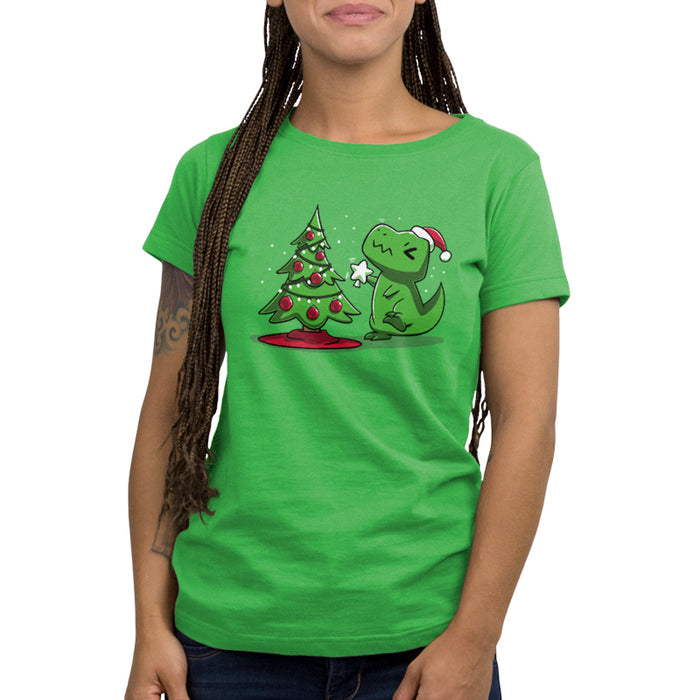 Premium Cotton T-shirt_TeeTurtle Christmas T-Rex apple t-shirt featuring a cartoon dinosaur wearing a Santa hat placing a star atop a Christmas tree adorned with red baubles and lights.