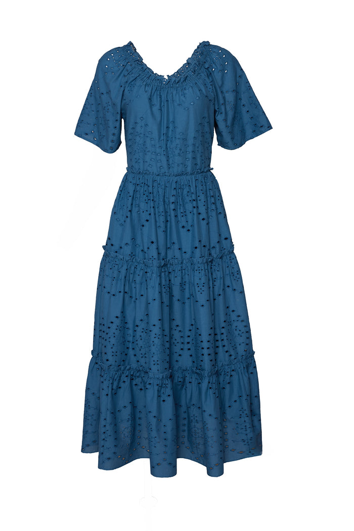 The Etta Dress in Cobalt by Ivy City Co features short flutter sleeves, a ruffled neckline, ankle-length tiered skirt, and allover eyelet embroidery on cotton—making it the ideal summer midi dress.
