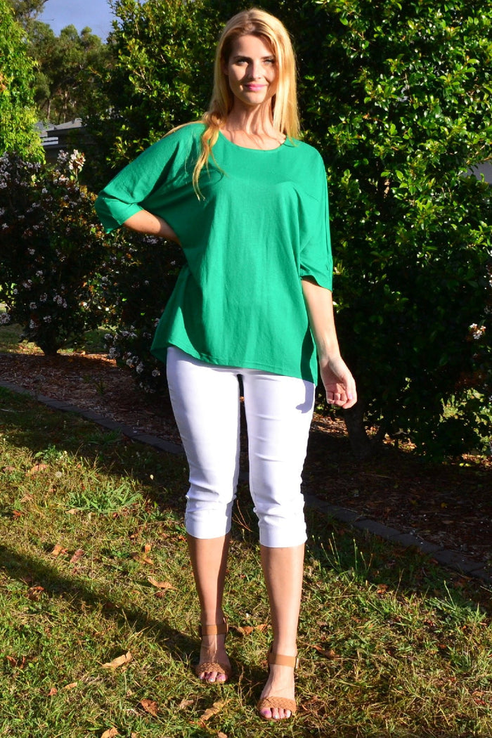 Grass green Stylius sloping sleeve tunic top with a relaxed fit, shown on a hanger against a plain background.