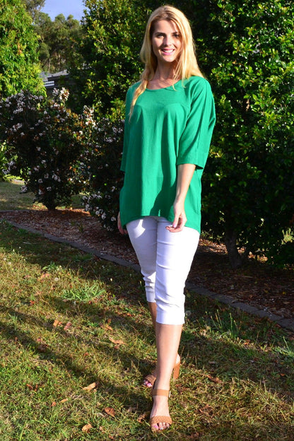 Grass green Stylius sloping sleeve tunic top with a relaxed fit and flowing silhouette, displayed on a hanger.