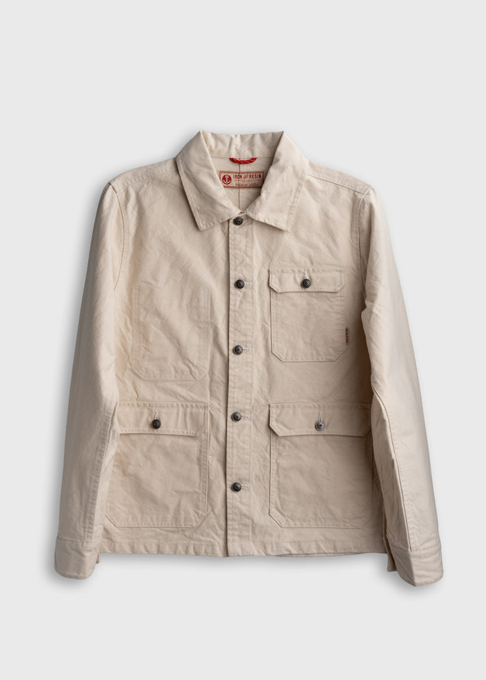Beige canvas jacket with button closure and multiple pockets, displayed against a white background.