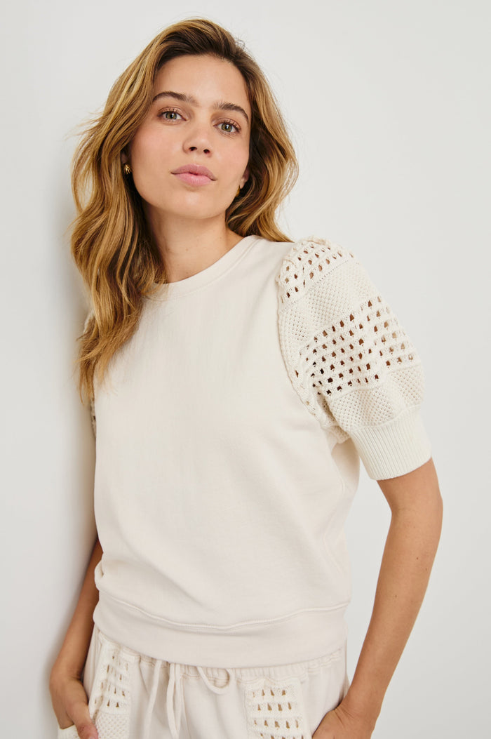 Kimberly Sweatshirt with Elbow-Length Sleeves, Ribbed Cuffs, Crew Neckline, and Crochet and Knit Sleeves in Oat Colorway - Front View Featured on Model