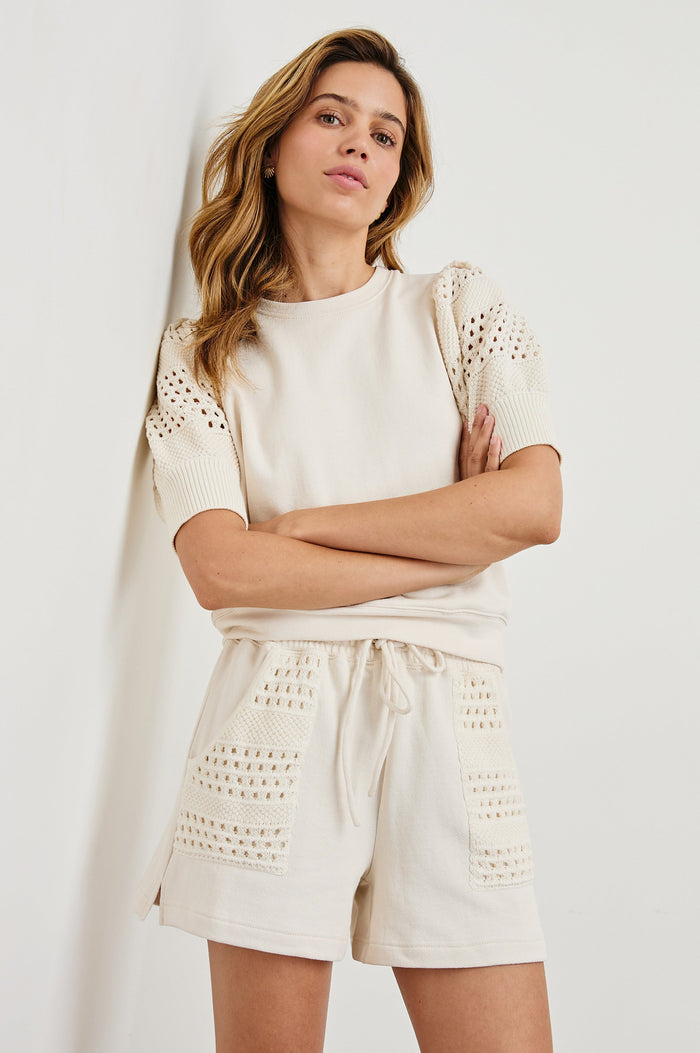 Kimberly Sweatshirt with Elbow-Length Sleeves, Ribbed Cuffs, Crew Neckline, and Crochet and Knit Sleeves in Oat Colorway - Front View Featured on Model