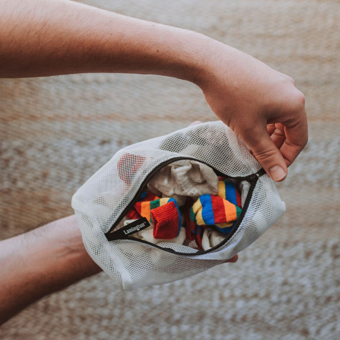 Sock-sized laundry bag with socks inside. Open zip