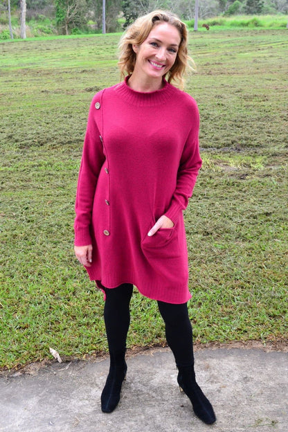 Magenta high neck cosy knit tunic jumper by Wishstone, shown on a hanger with textured fabric and ribbed cuffs.