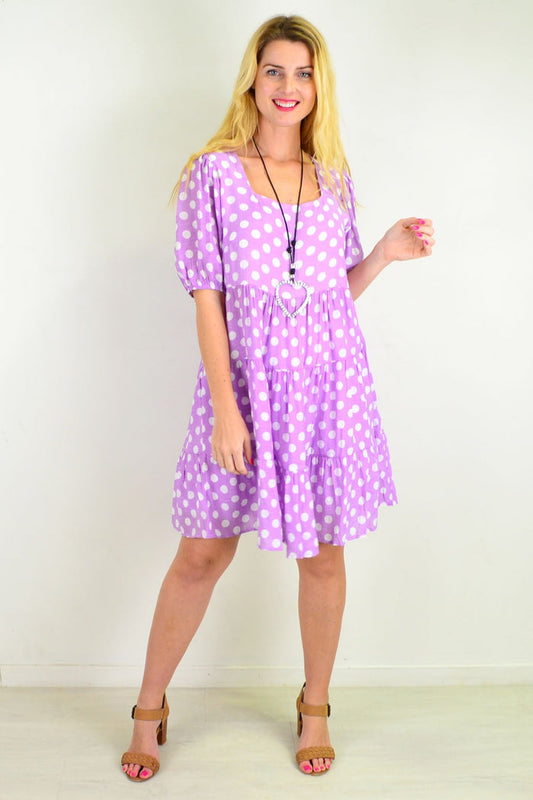 Purple mauve tunic dress with polka dots and puff sleeves by Hourglass, featuring a tiered design and white spots.