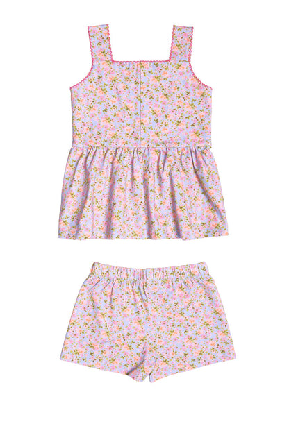 The Mini Blair Play Set in Vibrant English Garden by Ivy City Co is a matching children’s set featuring a sleeveless square-neck top with a gathered fit and comfy elastic-waist shorts, crafted in light pink floral stretch fabric.