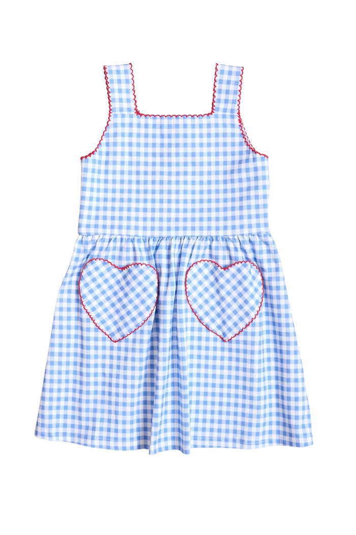 The Mini Rue Play Dress in Vichy Gingham by Ivy City Co is a cotton, sleeveless blue and white gingham girls’ summer dress with red trim and two heart-shaped front pockets.