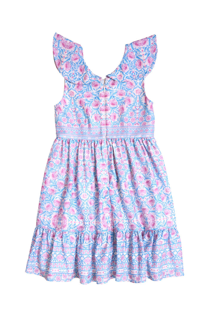 The Mini Samara Dress in Thistle Flower Mosaic Florise by Ivy City Co is a sleeveless girls’ dress with ruffled shoulders, a fitted bodice, and a flared skirt. Its fabric showcases an elegant blue and pink floral pattern with decorative borders—ideal for adorable Mom and Me matching moments.