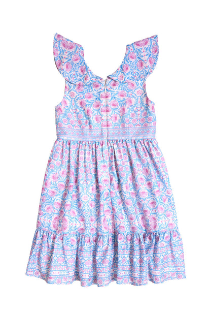 The Mini Samara Dress in Thistle Flower Mosaic Florise by Ivy City Co is a sleeveless girls’ dress with ruffled shoulders, a fitted bodice, and a flared skirt. Its fabric showcases an elegant blue and pink floral pattern with decorative borders—ideal for adorable Mom and Me matching moments.