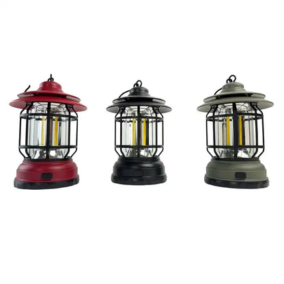 Three hanging lanterns in red, black, and green