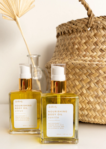 Vanilla scented nourishing dry body oil bottles sitting in front of a basket