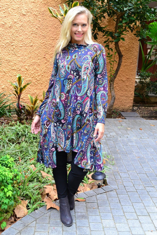 Hourglass Penelope Paisley fleece tunic dress hanging on a mannequin, showcasing its relaxed fit and vibrant paisley pattern.