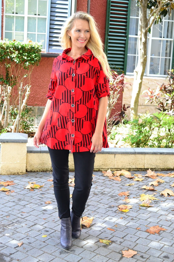 Red deck of cards high collar tunic shirt by Ruby Rain, featuring a stylish design and a high neckline, displayed on a hanger.