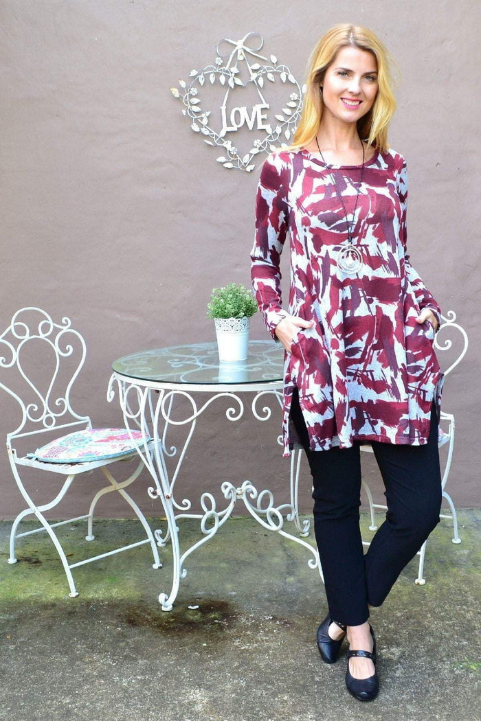 Red paint splash fleece tunic top by Hourglass, featuring a bold red paint splash design and cozy fleece fabric.