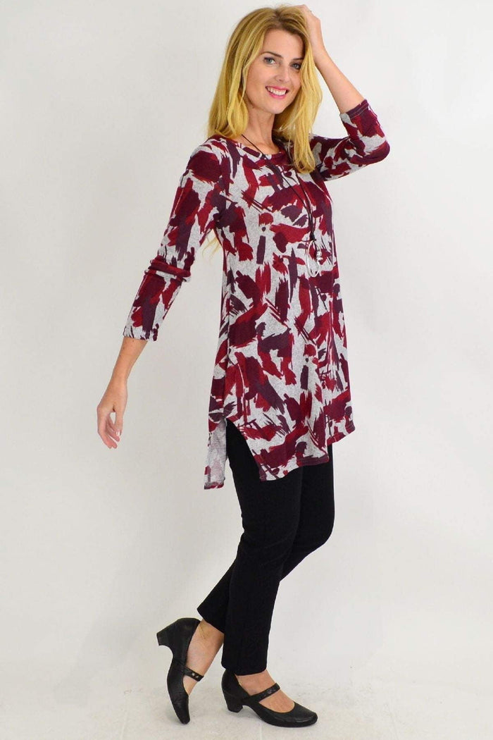Red and grey paint splash fleece tunic top by Hourglass, featuring a relaxed fit and artistic design, perfect for casual wear.