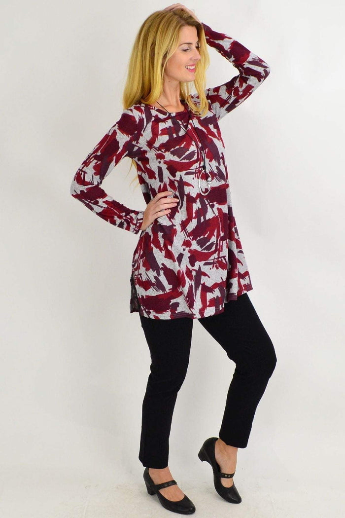 Red and grey paint splash fleece tunic top by Hourglass, featuring a vibrant, artistic design on a comfortable, casual garment.