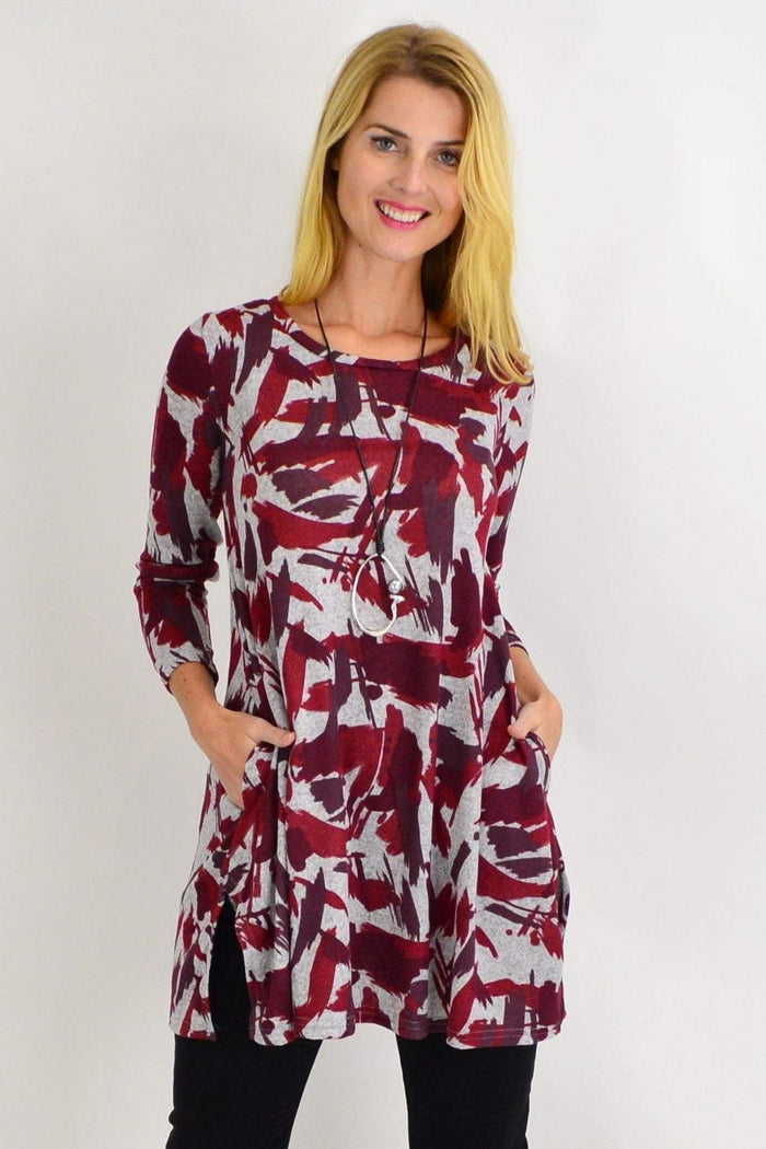 Red fleece tunic top with grey paint splash design by Hourglass, featuring a relaxed fit and casual style.