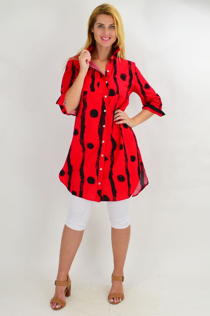 Red tunic shirt with black dots by Ruby Rain, featuring a loose fit and casual style, displayed on a hanger.