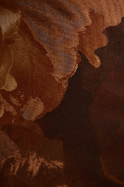 Close-up of stretch mesh fabric with blurred mocha brown floral print on the Rosalia maxi dress.