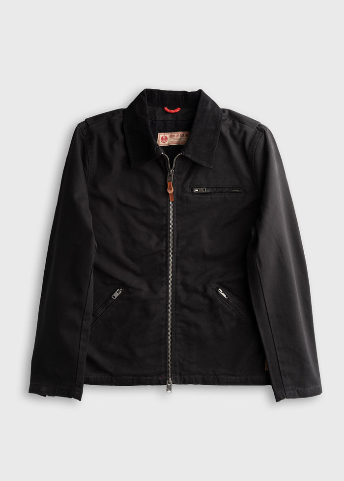 Black jacket with a front zipper, two side pockets, and a chest pocket, laid flat on a white background.