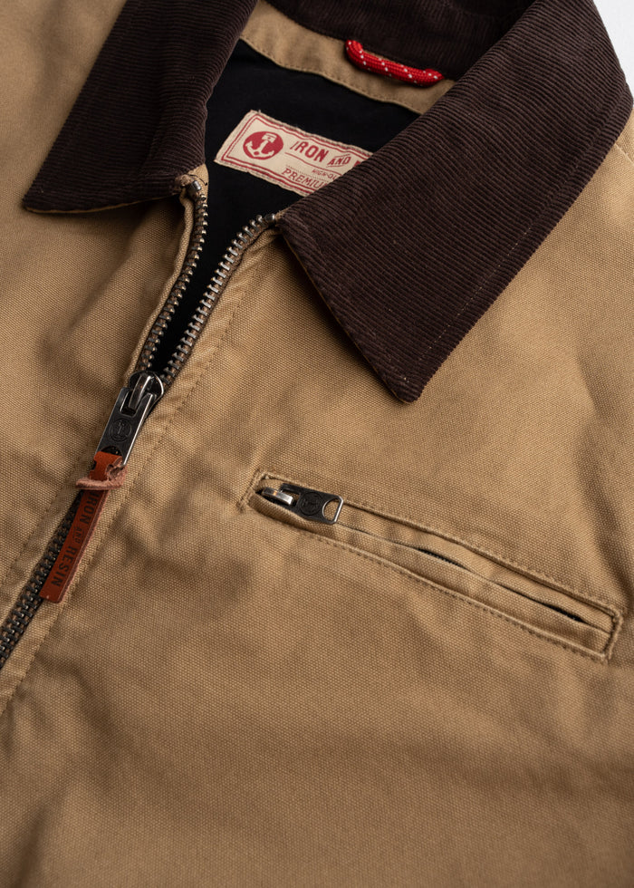 Brown jacket with a corduroy collar, visible zipper, and label reading "Iron and Resin." The fabric appears durable and stylish.