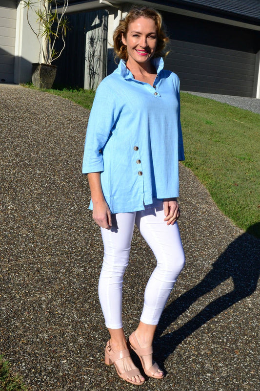 Sky blue high collar tunic shirt by Ruby Rain, featuring a stylish high neckline and comfortable fit, displayed on a hanger.