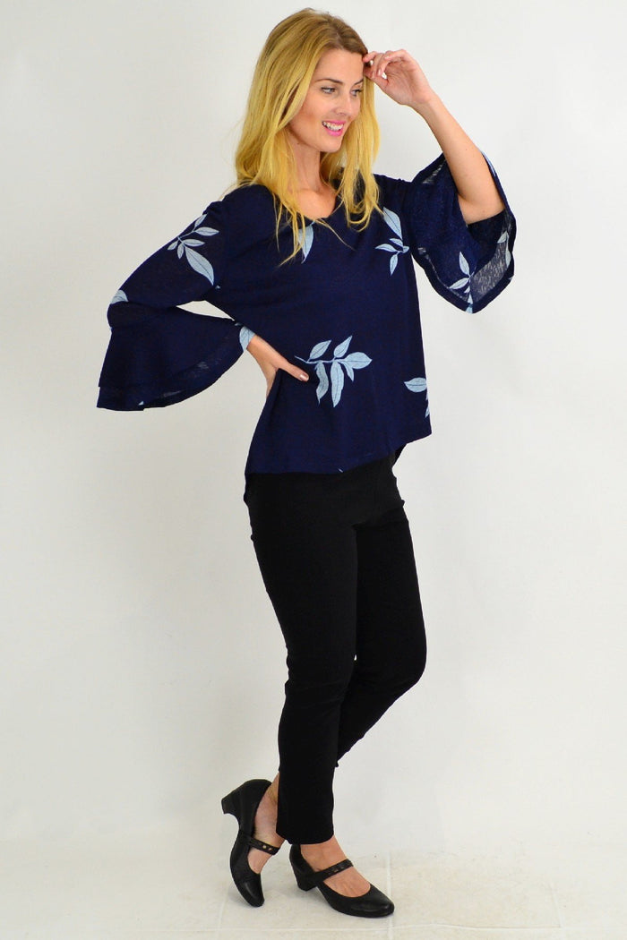 Stylish Spanish Leaf Bell Sleeve Tunic Blouse by Stylius with bell sleeves and leaf print fabric, displayed on a hanger.