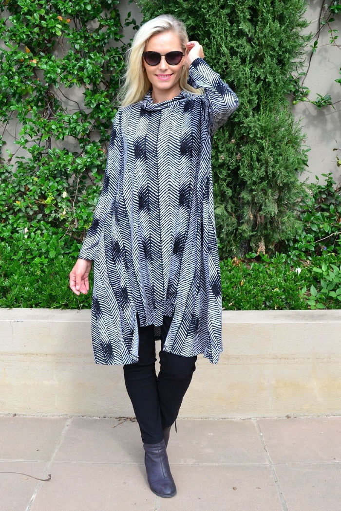 Hourglass Zig Zag black and grey fleece tunic dress with a relaxed fit, featuring a bold zig zag pattern and long sleeves.