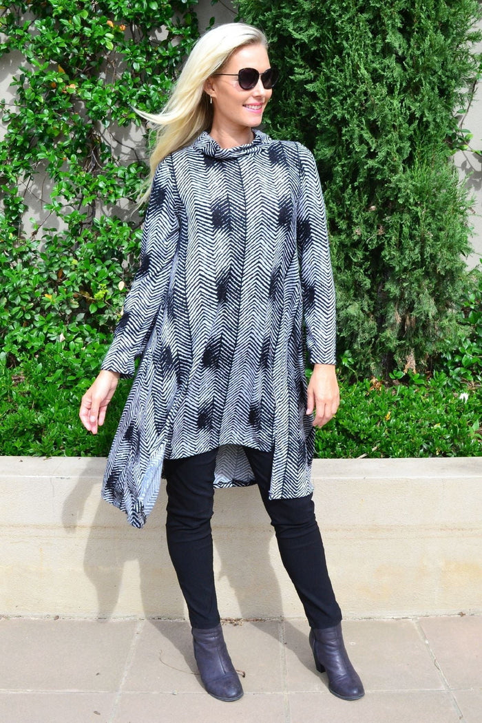 Hourglass zig zag black and grey fleece tunic dress featuring a relaxed fit and long sleeves, displayed on a hanger.