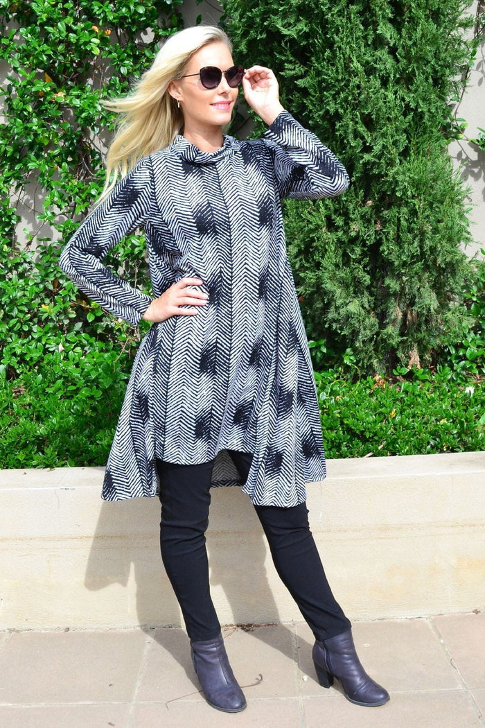 Hourglass Zig Zag black and grey fleece tunic dress with a relaxed fit and long sleeves, displayed on a hanger.